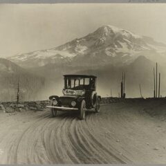 Vintage image of a Detroit Electric car on a promotional tour through mountains from Seattle to Mt. Rainier in 1919.