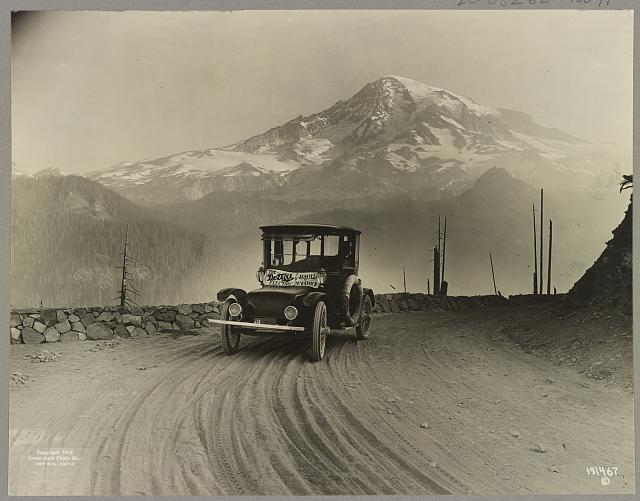Vintage image of a Detroit Electric car on a promotional tour through mountains from Seattle to Mt. Rainier in 1919.