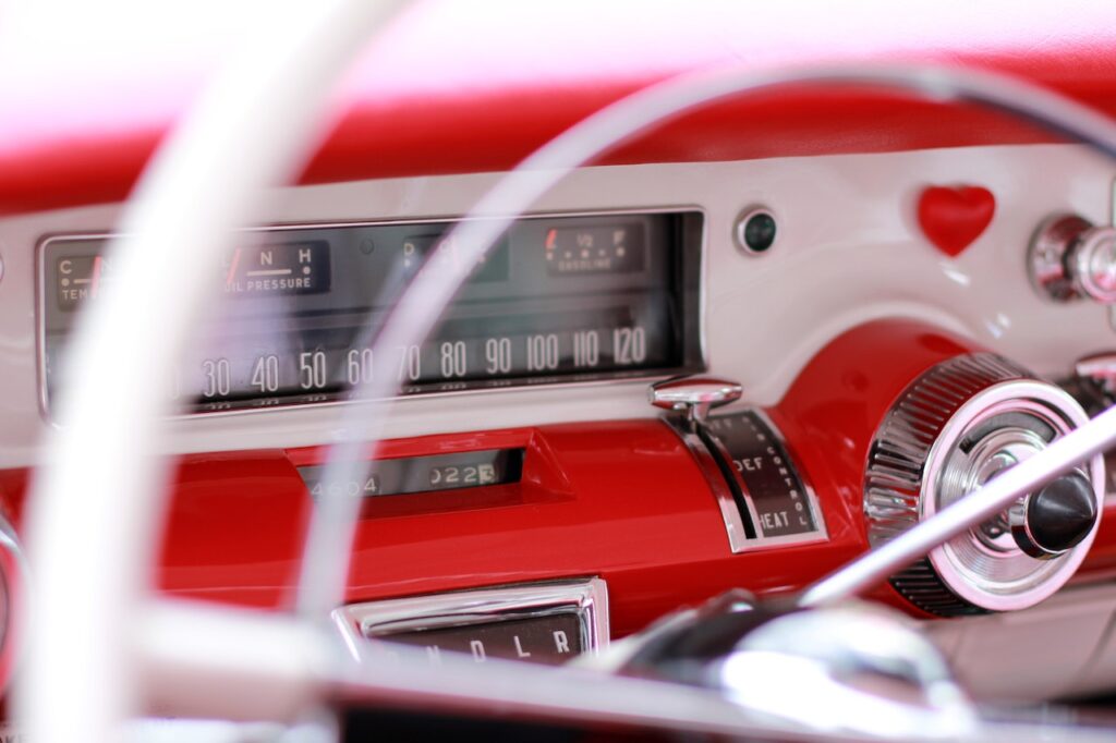 A view of the dashboard through the steering wheel on a classic American petrol car.